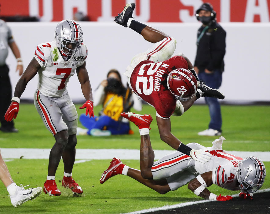 Sports - 3rd place - January - Alabama running back Najee Harris (22) dives into the end zone over Ohio State safety Josh Proctor (41) on his way to scoring a 26-yard touchdown during the second quarter of the College Football Playoff National Championship game at Hard Rock Stadium in Miami Gardens, Fla.  (Kyle Robertson / The Columbus Dispatch)