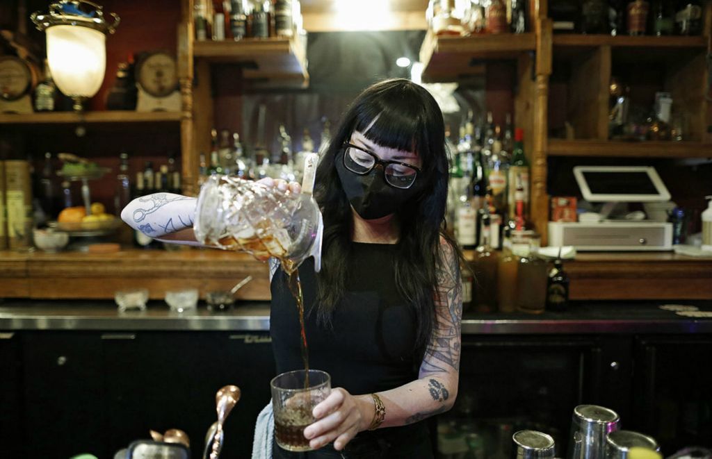 Portrait - 2nd place - February - Bartender Shea Bainbridge makes a drink at Two Truths bar in Columbus. The bar has been busier since the statewide curfew was pushed back to 11 p.m., and will likely be moved back again if COVID cases continue to go down. (Kyle Robertson / The Columbus Dispatch)