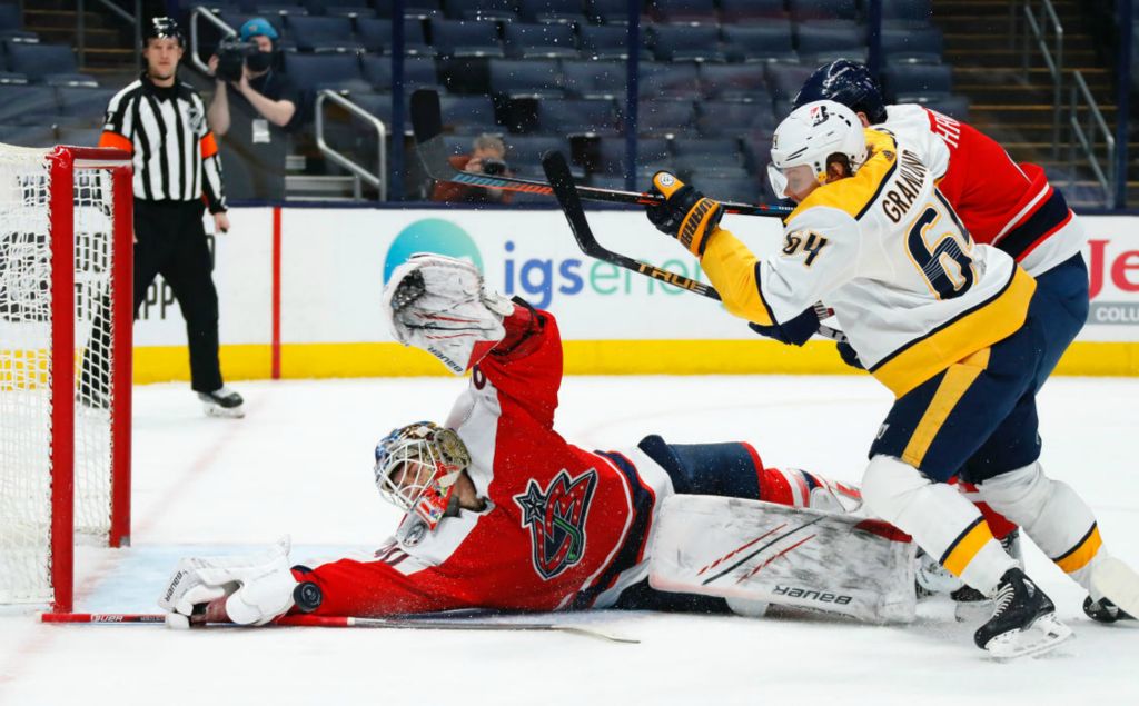 Sports - 1st place - February - Columbus Blue Jackets goaltender Elvis Merzlikins (90) makes a diving save of a Nashville Predators center Mikael Granlund (64) shot during the second period of their game at Nationwide Arena in Columbus. (Kyle Robertson / The Columbus Dispatch)