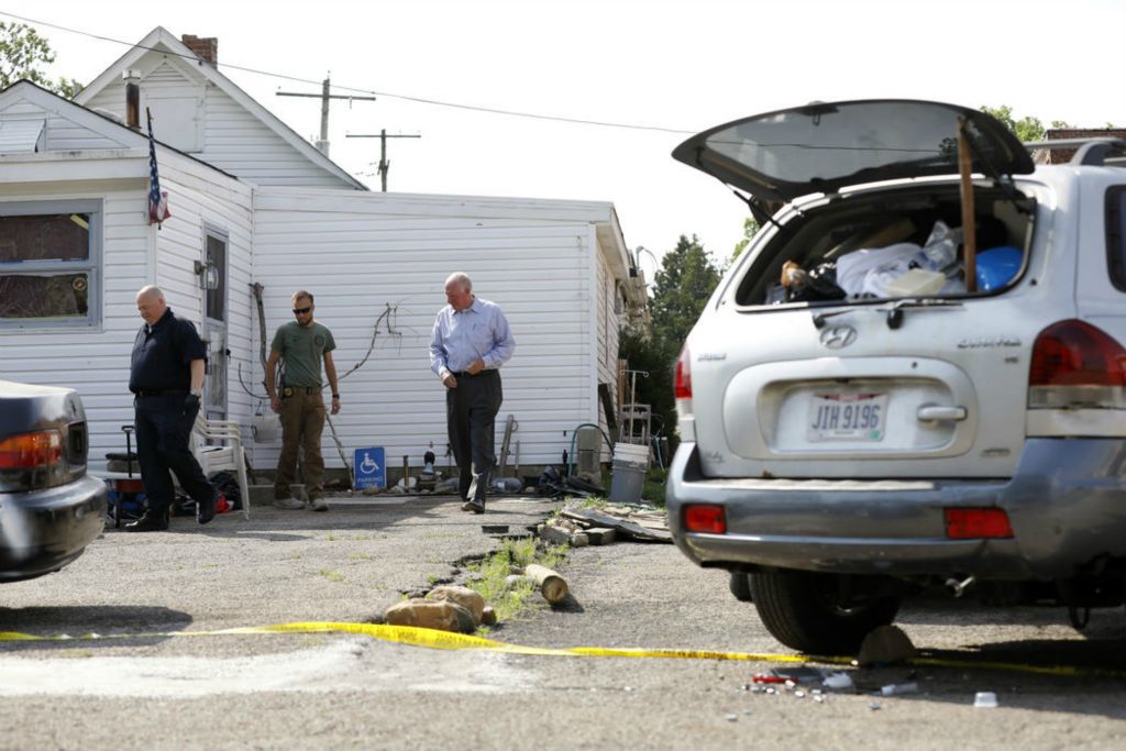 Spot News - 3rd place - May -  Investigators look over the crime scene after at least three people are dead following a shooting in West Jefferson, a town about 20 miles west of Columbus.  (Kyle Robertson / The Columbus Dispatch)  