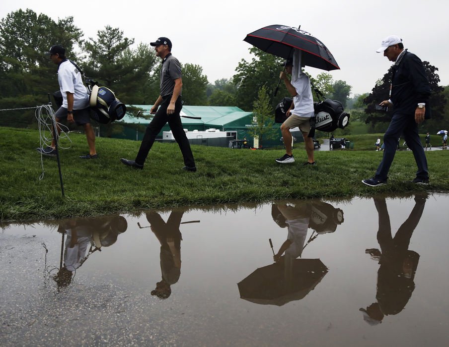 Sports Feature - HM - June - Jimmy Walker (left center) walks up to the 11th hole after raining in the morning during Round 1 of The Memorial Tournament at Muirfield Village Golf Club in Dublin. (Kyle Robertson / The Columbus Dispatch)