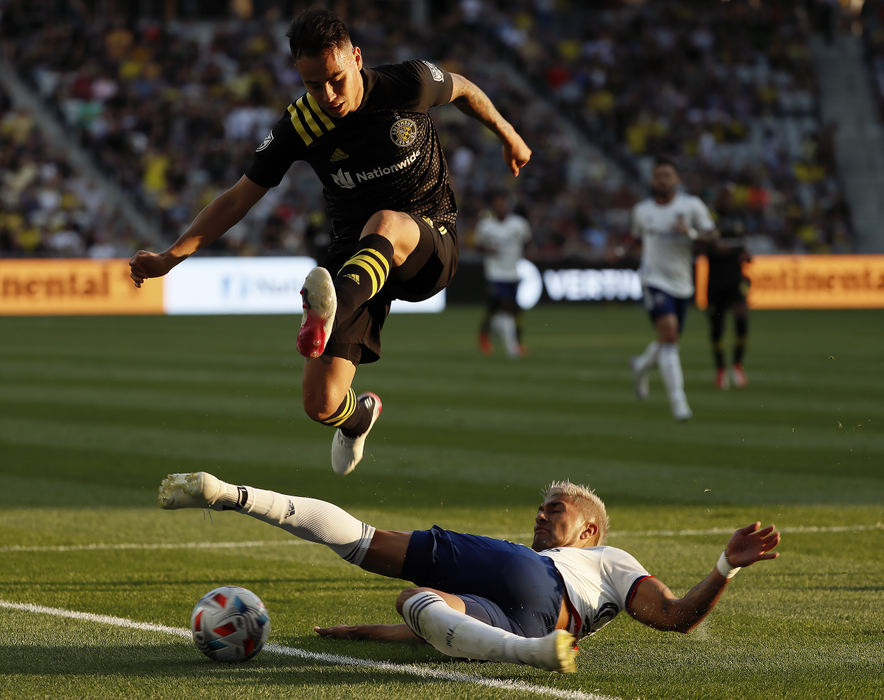 Sports - 2nd place - August - Columbus Crew midfielder Lucas Zelarayan (10) jumps over D.C. United defender Tony Alfaro (93) during the first half of their MLS game at Lower.com Field in Columbus.  (Kyle Robertson / The Columbus Dispatch)