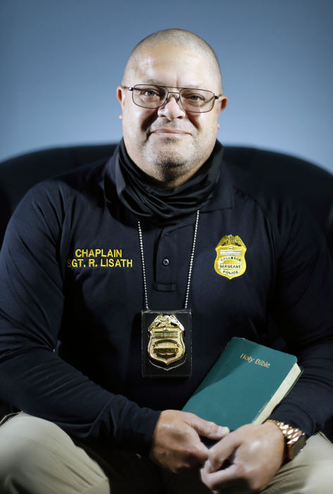 Portrait - 3rd place - October - Lt. Roy Lisath a chaplain and officer with Columbus Police poses for a photo at Grace and Mercy Fellowship Center in Columbus.  Columbus Police Chief Elaine Bryant said she wants 100 chaplains by 2026 in a talk at the Metro Club earlier this month. Columbus Police have 9 chaplains, including Roy.  (Kyle Robertson / The Columbus Dispatch) 