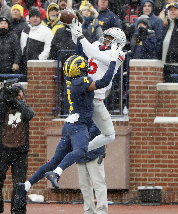 Sports - 2nd place - November - Ohio State wide receiver Garrett Wilson (5) makes a touchdown catch against Michigan defensive back Vincent Gray (4) during the second quarter of their game at Michigan Stadium at Ann Arbor, Michigan.(Kyle Robertson / The Columbus Dispatch)