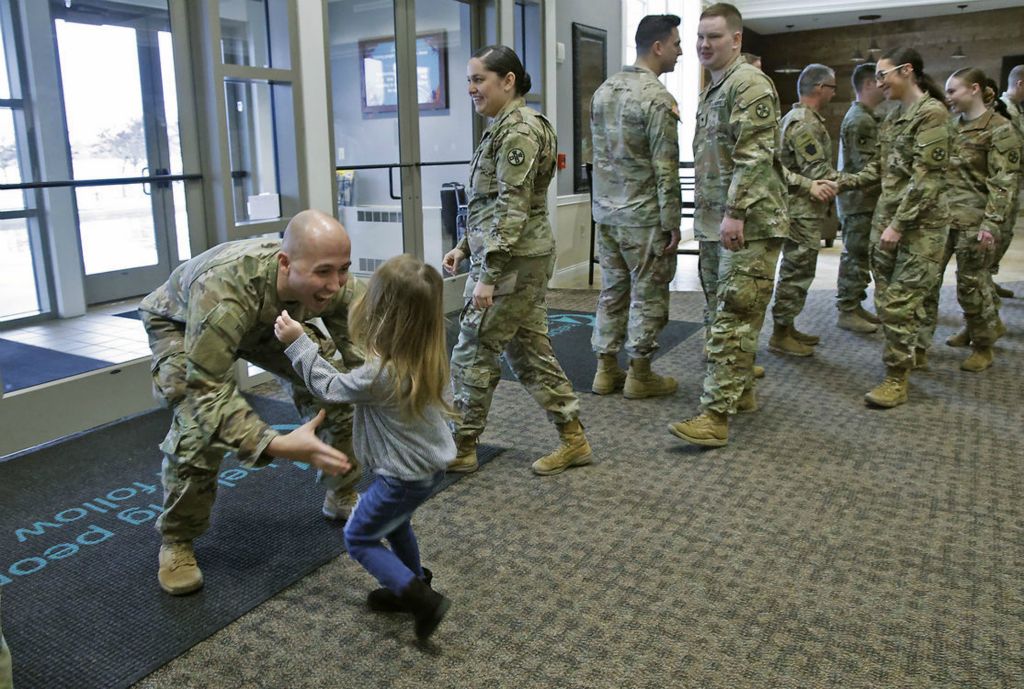 General News - HM - Amelia Bernabei runs into the arms of her father, SSgt. Joey Bernabei at the conclusion of a Call To Duty Ceremony honoring the Ohio Army National Guard's 1137th Signal Company who are deploying for nine months in Support of U.S. Central Command. About 30 members of the Springfield Company are deploying and participated in the ceremony at The First Christian Church on Middle Urbana Road.  (Bill Lackey / Springfield News-Sun)