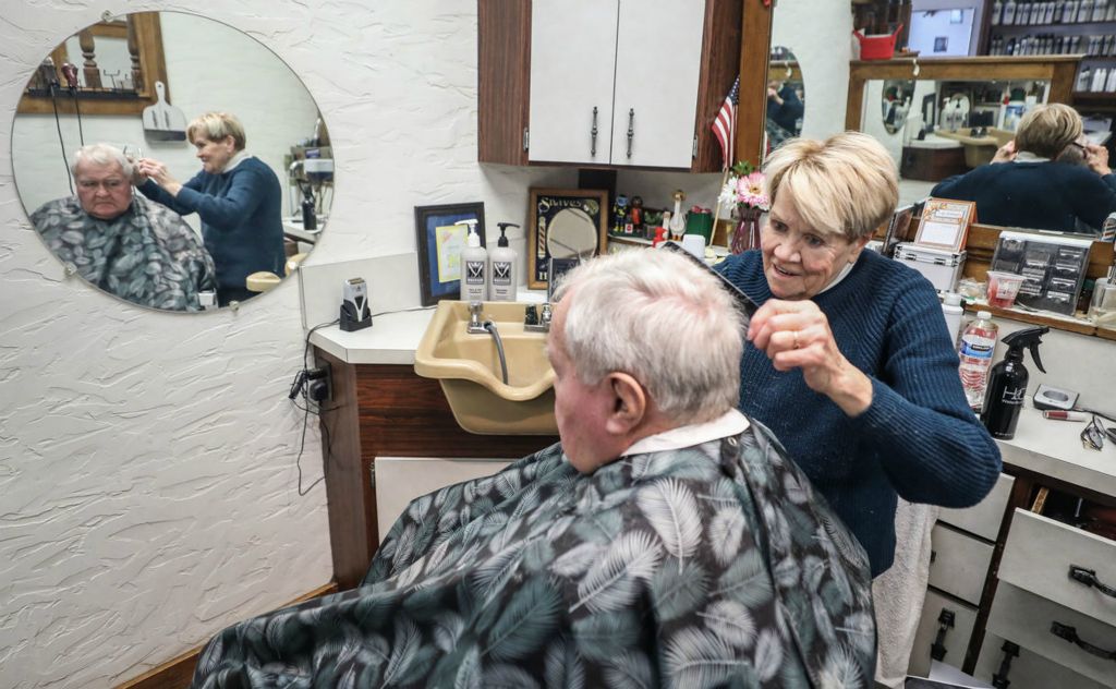 Portrait - 1st place - Connie Durand, 75, cuts Paul Brzozka’s  hair at the Golden Razor Barber Shop in Toledo.  (Jeremy Wadsworth / The Blade)