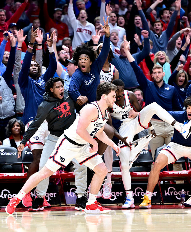 Sports Feature - HM - The Dayton Flyers Bench reacts with excitement as walk on player Brady Uhl hits a 3 point basket during a 96-62 win over Rhode Island. (Erik Schelkun / Elsestar Images)
