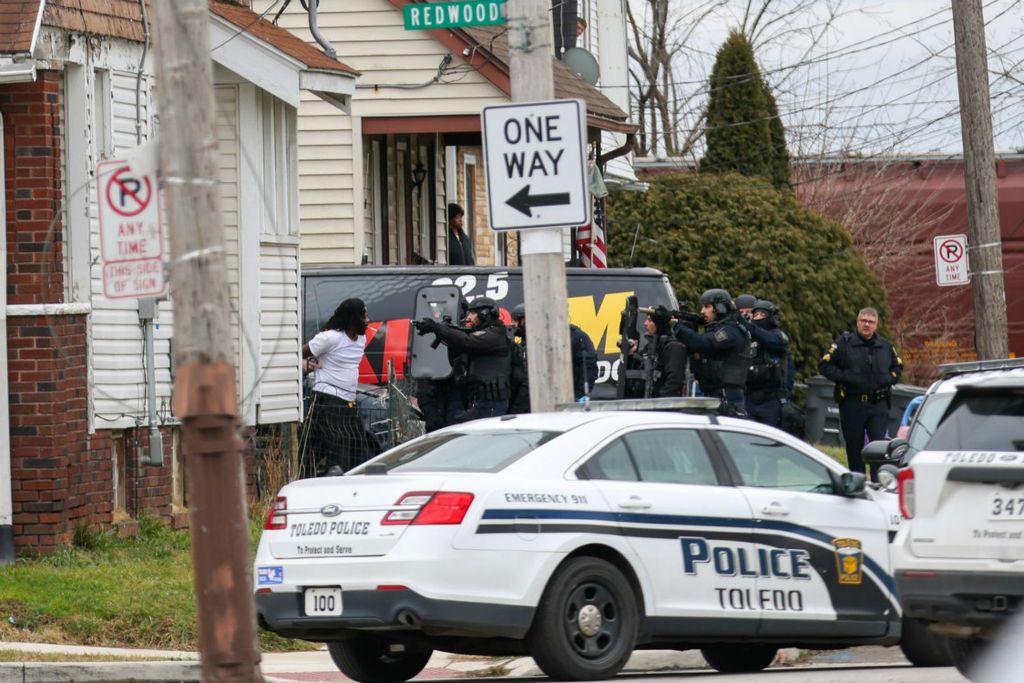 Story - 3rd place - The man who held two people hostage gives himself up to police during a police standoff at the intersection of Redwood Avenue and Bowman street in Toledo.  (Jonathan Aguilar / The Blade)