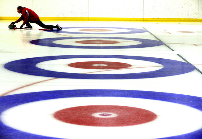 Sports Feature - 3rd place - A curler practices sliding a stone at the Chiller. The NTPRD Chiller is hosting its first curling tournament drawing teams from across the U.S. and Canada, as well as an Olympic athlete.  (Bill Lackey / Springfield News-Sun)
