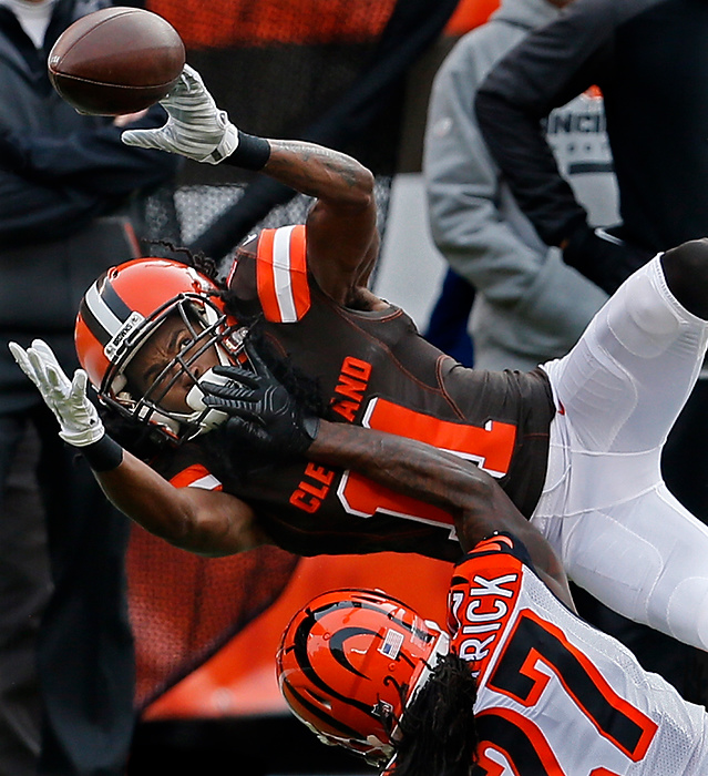 First Place, Sports Action - Ed Suba Jr. / Akron Beacon JournalCleveland Browns wide receiver Travis Benjamin keeps an eye on a pass while floating above Cincinnati Bengals cornerback Dre Kirkpatrick in the Browns 37-3 loss to the Bengals.
