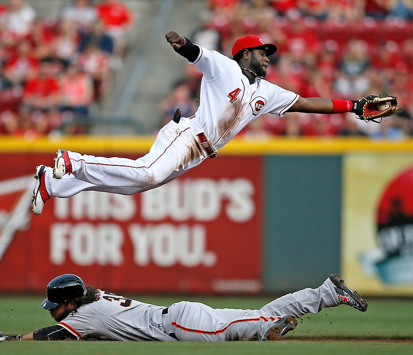 Third Place, Sports Action - Sam Greene / Cincinnati EnquirerCincinnati Reds second baseman Brandon Phillips (4) leaps to save a wild pick-off throw down to second base as San Francisco Giants shortstop Brandon Crawford (35) slides in safely on a steal during the top of the second inning at Great American Ballpark in Cincinnati.