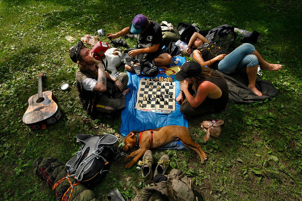 , Student Photographer of the Year - Eli C. Hiller / Ohio UniversityFrom left, Steve West, Alex Johnson, Jake Nelson and Lindsey Martin hang out in Goodale Park in Columbus, Ohio on July 12, 2015. The four hitchhiked from Youngstown to Columbus and are headed to Maine to work during the blueberry season. They identify themselves as travelers or Dirty Kids, a term that refers to a young generation of homeless traveling youth. They normally travel by means of hitchhiking and freight train hopping. "Life isn't about going home and watching Netflix or going to the bars every night after a day's work," said Nelson. "It's about experiences and meeting new people."