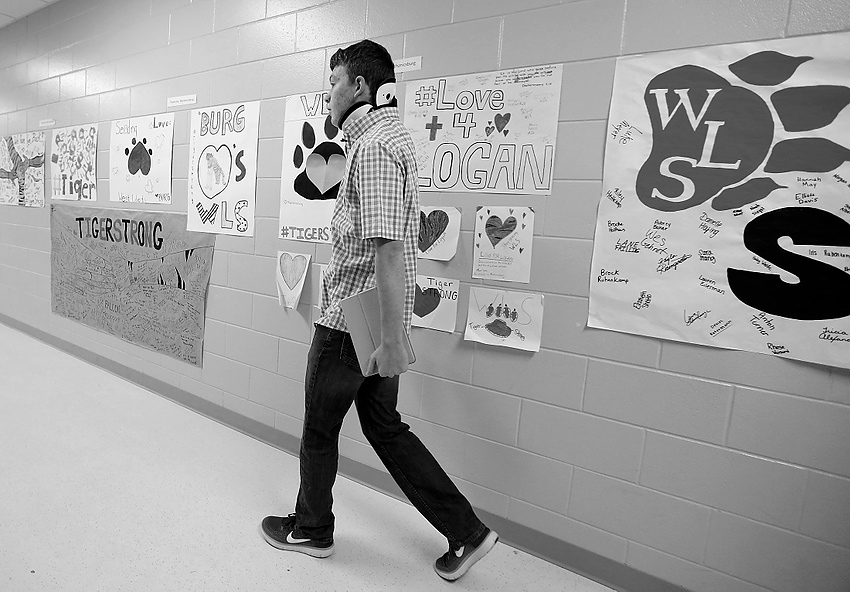 Second Place, Feature Picture Story - Jonathan Quilter / The Columbus DispatchLogan walks down a hallway decorated with signs supporting him and his school at West Liberty-Salem High School. Logan was adjusting to his first full week back at school after spending 15 days in Nationwide Children’s Hospital in Columbus fighting for his life and then eventually returning to school part-time.