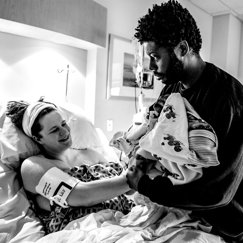 Third Place, Feature Picture Story - Jessica Phelps / Newark AdvocateDesmond gingerly reaches for his newborn daughter Rosalie for the first time at St. Ann's hospital in Westerville. Even though Rosalie is his fourth child, the excitement and fear of being responsible for their wellbeing still weighs heavily on him.