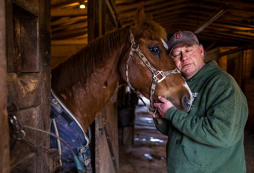 Award of Excellence, Feature Picture Story - Erin Clark / Ohio UniversityBrian Hopkins pauses to embrace his horse while he completes his regular, early morning feeding at Double C Ranch. Brian has been the ranch manager for over 30 years and in his opinion, prefers the company of his horses to people. 