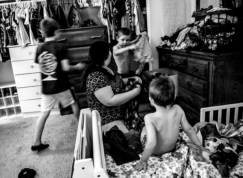Award of Excellence, Feature Picture Story - Jessica Phelps / Newark AdvocateCaity dresses the two younger boys, Beau and Max, for bed while Archer stirs up trouble next to them. The boys are always going at full speed, giving little rest to Caity and her husband who recently adopted them from the Ukraine. 