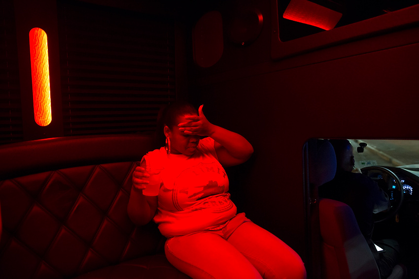 First Place, Feature Picture Story - Liz Moughon / Ohio UniversityMicheshia sips a drink in Master P's bus on the way to his concert in New Orleans, LA. A photo of Dequante was displayed for thousands  to see while Master P sang "I Miss My Homies."