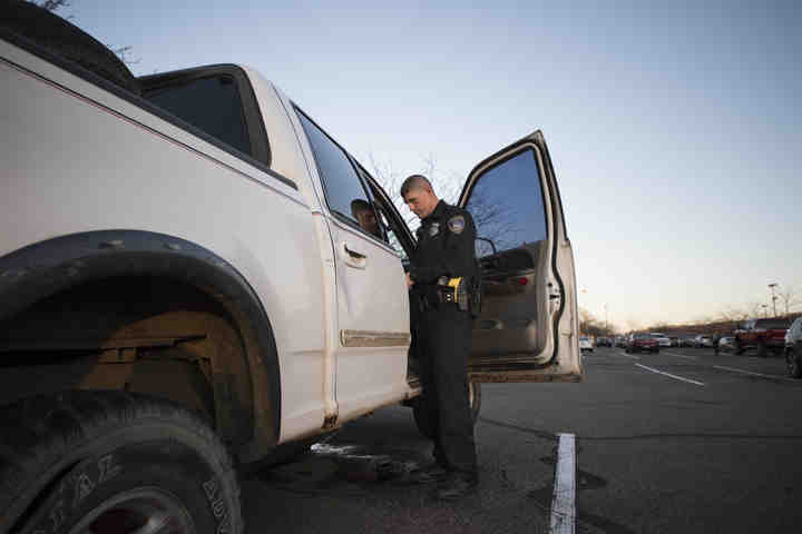 First place, Larry Fullerton Photojournalism Scholarsahip - Alexandria Skowronski / Ohio UniversityOfficer Andy Foster and the old truck left in Lowes parking lot since the weekend before Homecoming 2017 until December 1, 2017. (Alexandria Skowronski/Ohio University)