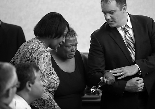 Award of Excellence, General News - Amy E. Voigt / The BladeAssistant prosecutor Frank Spryszak (right) helps victim Denise Glover's mother, Karen Reasonover go into the court to give her victim impact statement during the sentencing of Maurice Kenney for involuntary manslaughter and other charges for fatally shooting his live-in girlfriend Denise Glover.