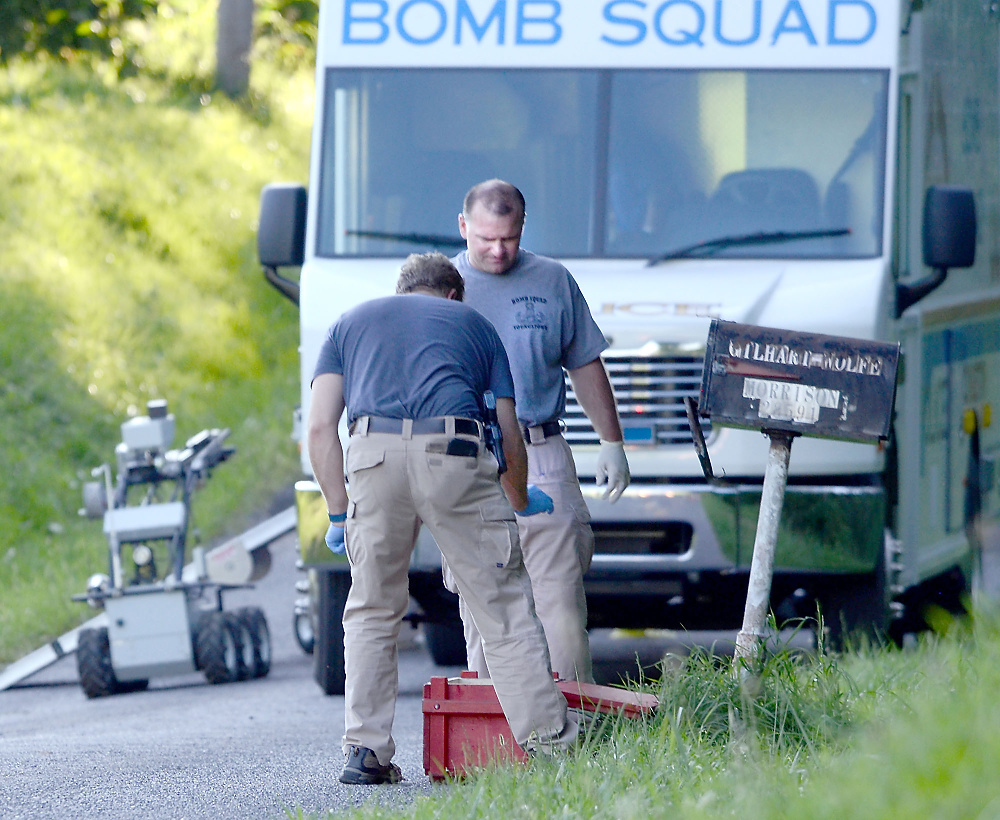 Third Place, News Picture Story - Patricia Schaeffer / The (Lisbon) Morning JournalBomb squad members Lt. Doug Bobovnyik and Officer Brad Ditullio remove the bomb by hand from the mailbox and place it in a case.