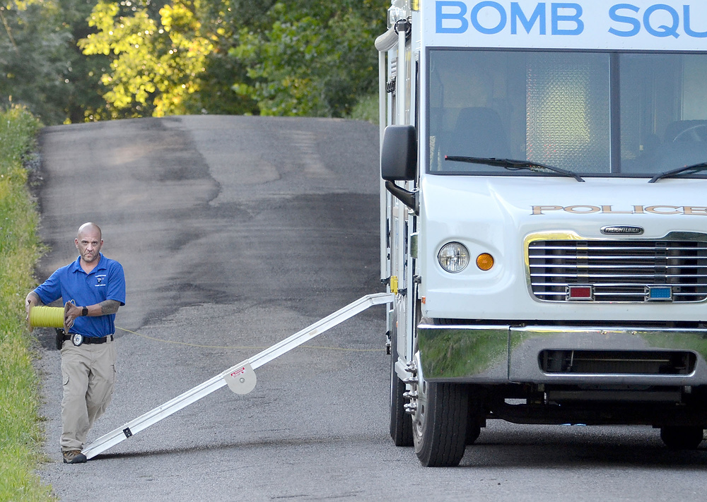 Third Place, News Picture Story - Patricia Schaeffer / The (Lisbon) Morning JournalBomb squad officer Bob DeMalio strings the detonation cord around the side of the bomb squad truck.