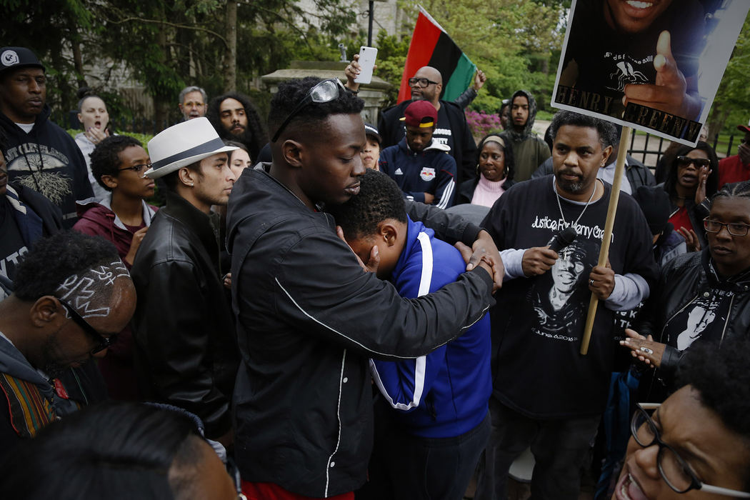 Geno Tucker, center left, embraces Solomon Wiley, 15, of Columbus, center right, as he becomes emotional after talking about his uncle, Jaron Thomas, as a crowd rallies in front of the Governor's mansion during the March for Justice on Saturday, May 6, 2017 in Columbus, Ohio. About 400 people from across the state gathered at Franklin Park to demonstrate for racial justice, advocate for good-paying jobs, criminal justice reform, investment in schools and public services and accountability from the justice system and elected officials. Both men had relatives who died during incidents with Columbus Police: Tucker was the uncle of 23-year-old Henry Green, who was shot and killed during an altercation with two plainclothes officers in South Linden. Thomas, 36, a North Linden resident who suffers from schizophrenia, died after police responded to his 911 call and after an altercation with officers. His family has filed a $2 million wrongful death lawsuit against the department. 