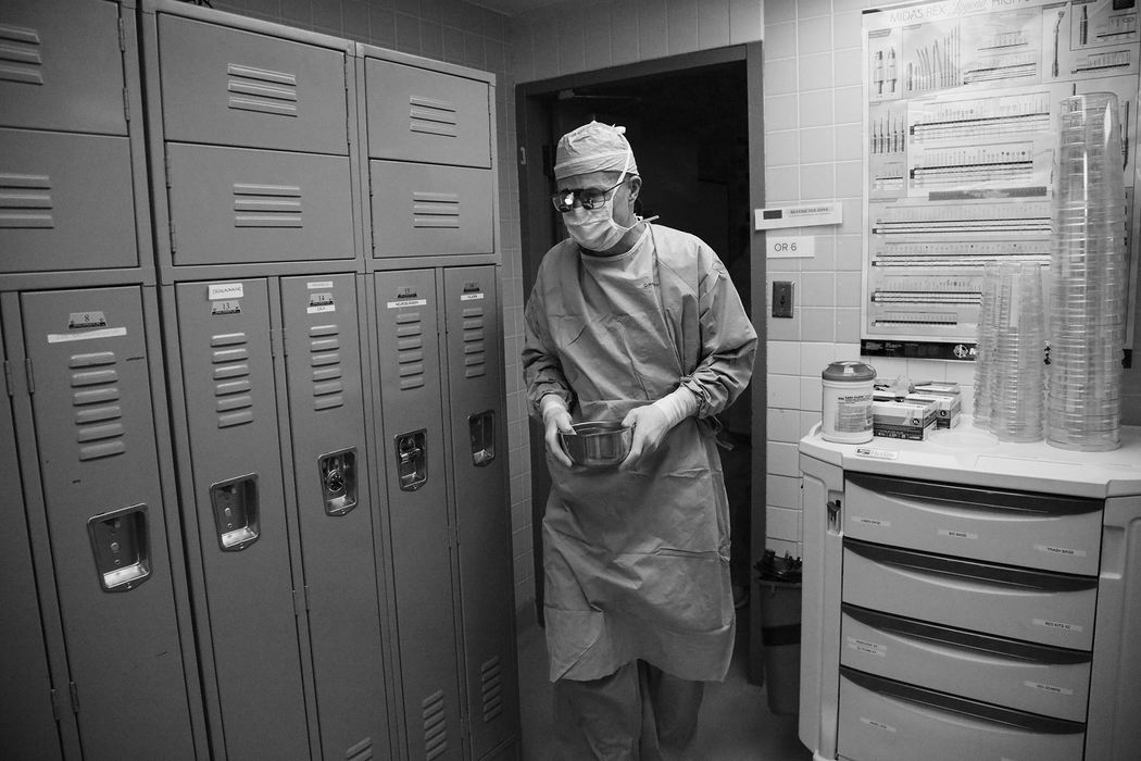 Dr. Ken Washburn exits Ann's operating room carrying a small metal bowl containing ice water and one of her kidneys as he walks toward the operating room of John Rimmer, the kidney's recipient, on Tuesday, February 14, 2017 at The Ohio State University Wexner Medical Center in Columbus, Ohio.