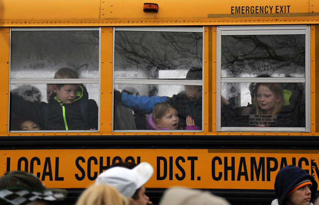 Children wait to exit the school bus to be picked up by their parents at Lion's Club Park after a shooting at the West Liberty-Salems school this morning in West Liberty, Ohio on January 20, 2017.   Champaign County Sheriff Matt Melvin says a 17-year-old student fired shots around 7:35 a.m. hitting 16-year-old junior Logan Cole multiple times with a shotgun.