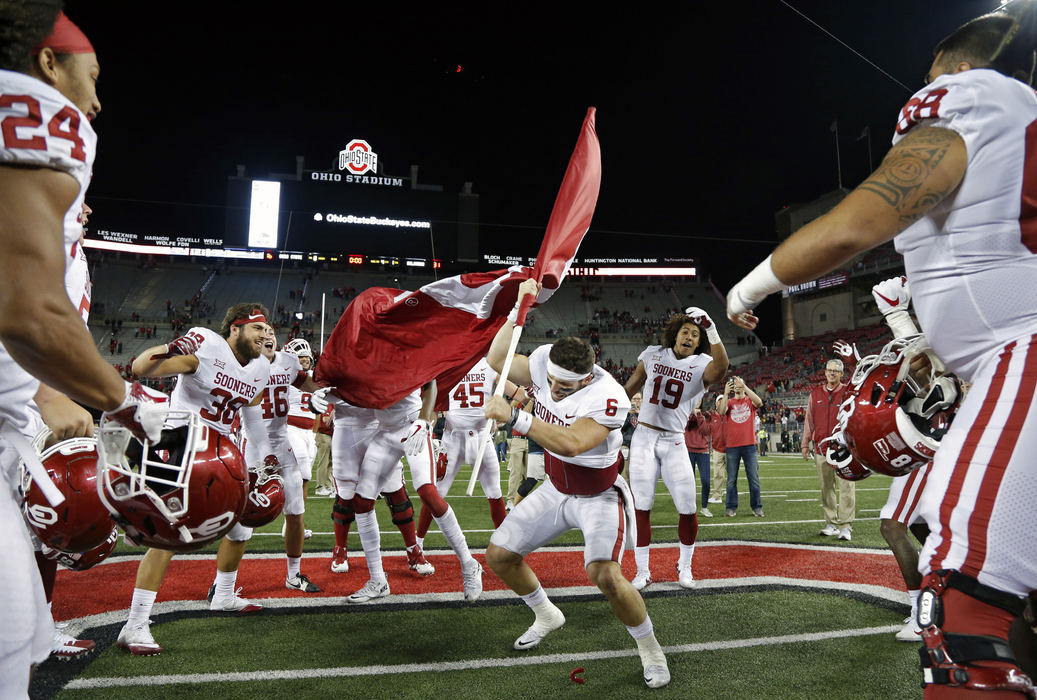Oklahoma Sooners quarterback Baker Mayfield (6) plants the Sooner flag in the Ohio State logo at midfield after beating Ohio State Buckeyes 31-16 at Ohio Stadium in Columbus, Ohio on September 9, 2017. 