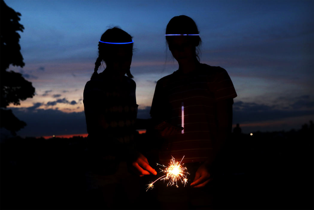 Maddie O'Dell, 13, left, and Sophie Twigg, 13, light their sparklers before the start of this year's fireworks display Monday, July 3, 2017, at Fort Meigs in Perrysburg. Thousands of area residents turned out on both sides of the Maumee River to watch the show, which included carnival rides and food at Fort Megs. The third of July is Maddie's birthday. 