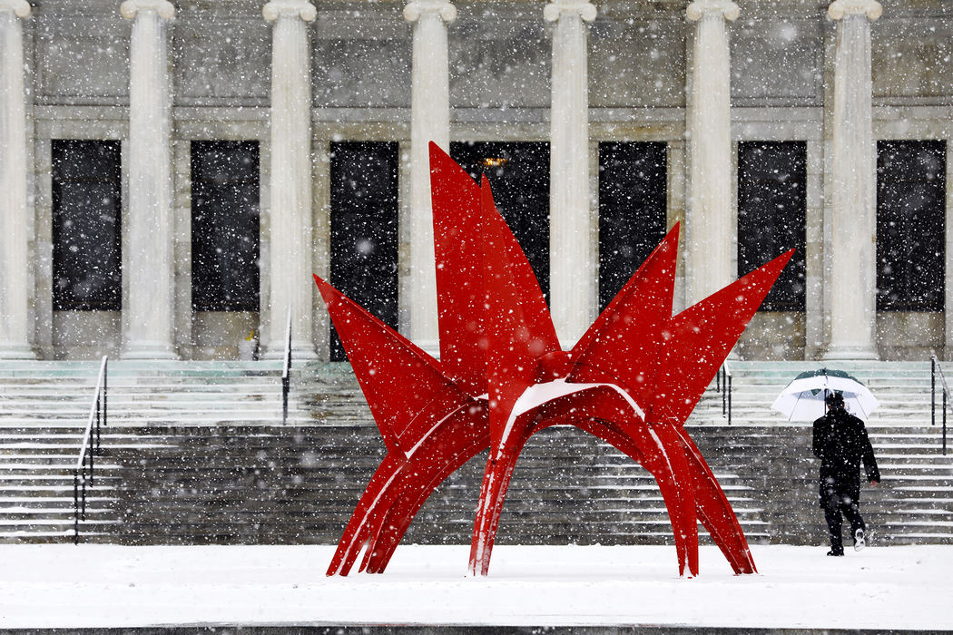 Snow flies as a man makes his way into the Toledo Museum of Art Wednesday, December 13, 2017, in Toledo. Flurries throughout the morning brought little accumulation. 