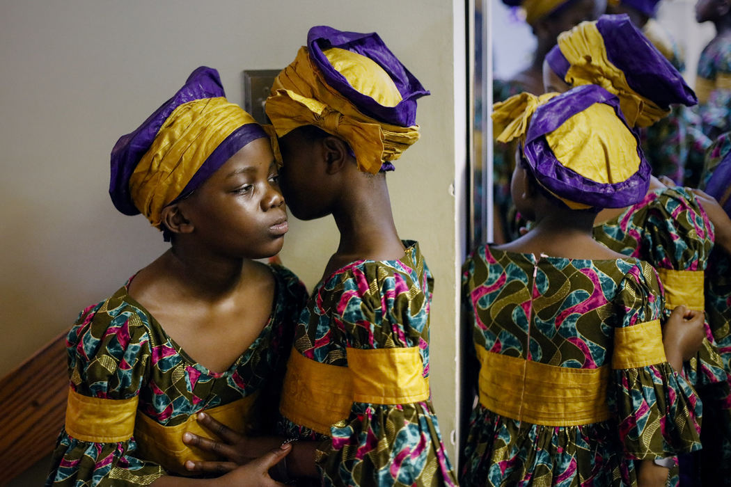Girls in the African Children's Choir wait in a hallway outside the sanctuary before performing on Sunday, January 1, 2017 at Karl Road Baptist Church in Columbus, Ohio. The choir, comprised of orphaned and other vulnerable African children aged 7 to 10-years-old, tours the United States and other countries to raise money for children from their home countries.
