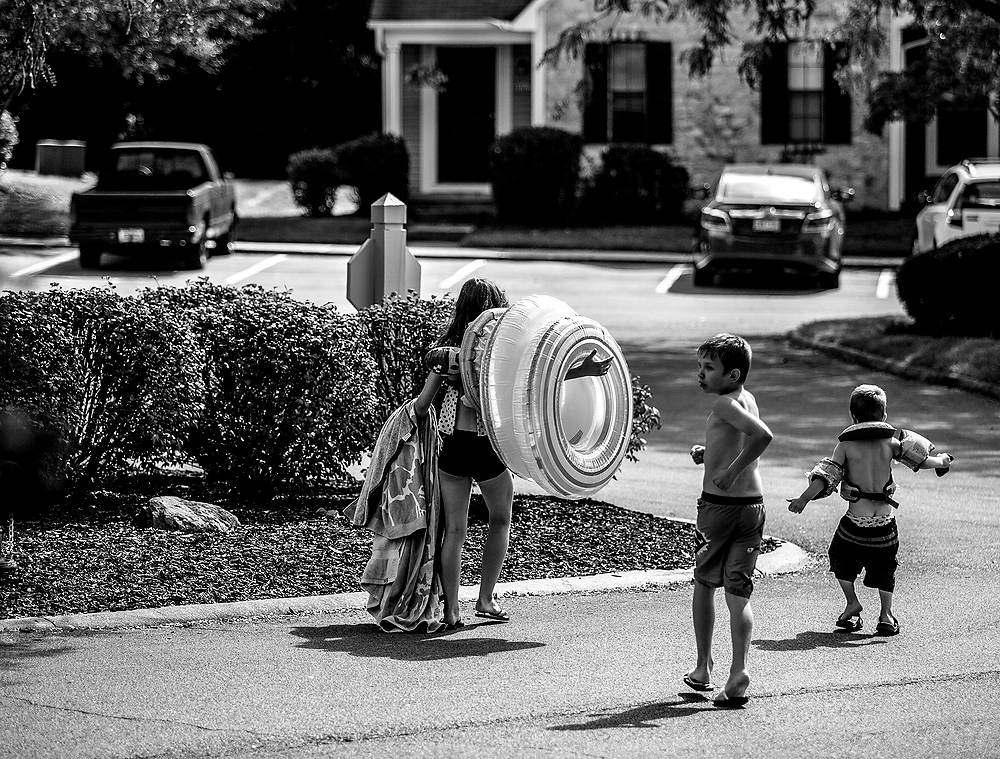 First Place, George S. Smallsreed Photographer of the Year  - Jessica Phelps / Newark AdvocateLera and her brothers, Archer and Max, hurry back to their new home after an impromptu morning at the pool. The three siblings, and their brother Beau, arrived in the United States just days before after being adopted from an orphanage in the war torn Eastern Ukraine. 