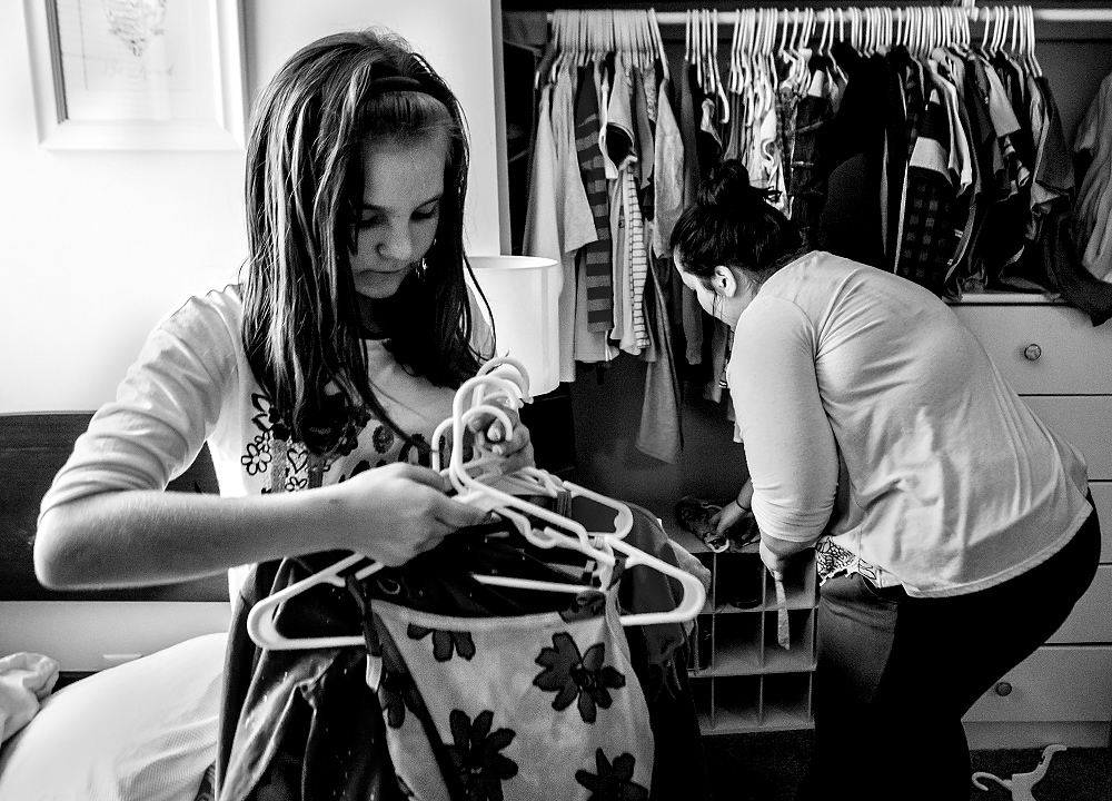 First Place, George S. Smallsreed Photographer of the Year  - Jessica Phelps / Newark AdvocateLera helps her Caity, her adoptive mom, Caity, clean the room she shares with her three brothers.