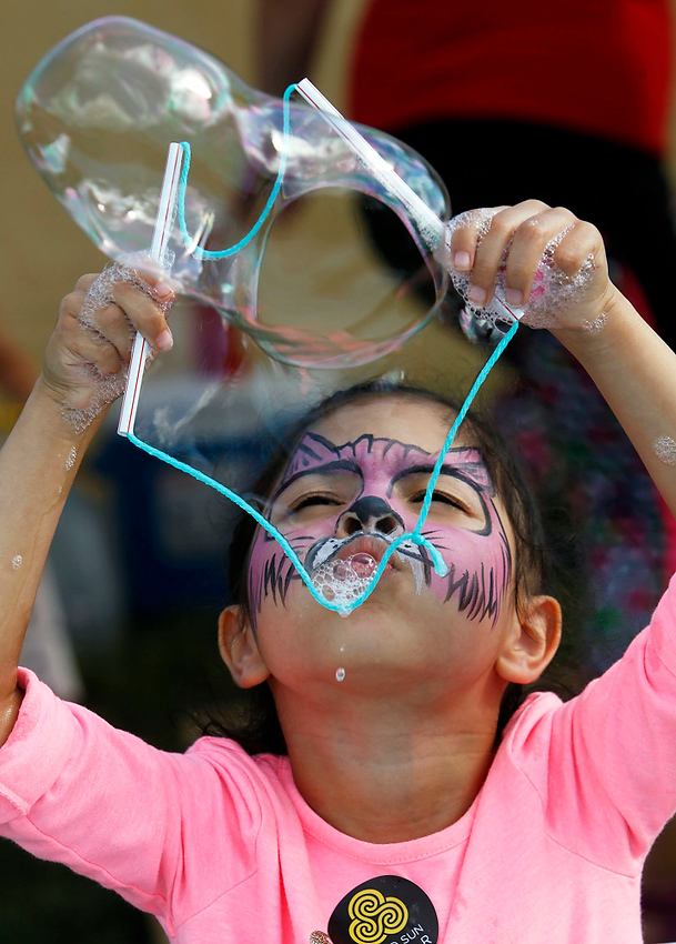 Second Place, George S. Smallsreed Photographer of the Year  - Lorrie Cecil / ThisWeek Community NewsSofia Morales, 5, of Reynoldsburg blows bubbles at the Reynoldsburg Lions Club booth at the 2017 Reynoldsburg Tomato Festival.