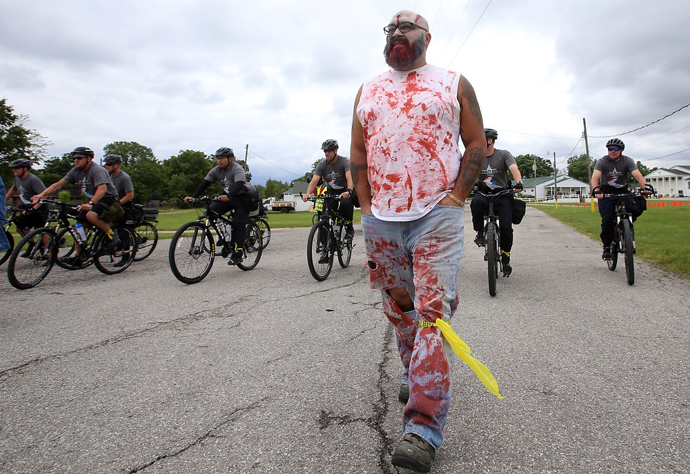 Second Place, George S. Smallsreed Photographer of the Year  - Lorrie Cecil / ThisWeek Community NewsWilliam Pettigrew of Crooksville is corralled up the road by bike officers during the International Police Mountain Bike Conference's crowd control exercise at the Delaware County Fairgrounds on Wednesday June 7.  As part of the exercise volunteers, most dressed as zombies, played an unruly crowd that the officers had to contain.  Officers from around the country and Canada participated in the exercise.  