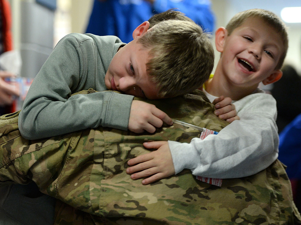 Third Place, George S. Smallsreed Photographer of the Year  - Erin McLaughlin / Sandusky RegisterBrothers Damian and Noah Rickey hug their dad, Army Specialist Marz Rickey, after his surprise arrival at Bataan Memorial Primary Elementary on Nov. 30, 2017, in Port Clinton. Their dad had been serving overseas for about a year before coming home to surprise his sons.