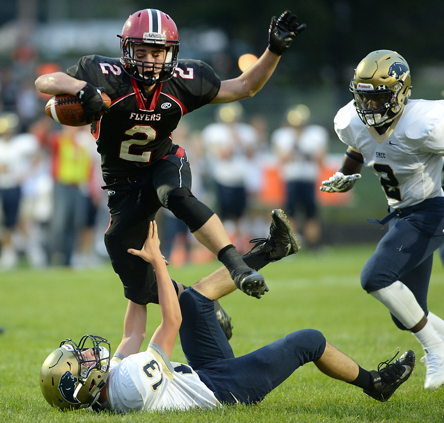 Third Place, George S. Smallsreed Photographer of the Year  - Erin McLaughlin / Sandusky RegisterSt. Paul's Noah Good escapes St. Mary's Kyle Pelz to score a touchdown during the last play of the second quarter at Whitney Field in Norwalk on Aug. 26, 2017. Good ran through two SMCC defenders over the final 10 yards, for a 39-yard touchdown pass.