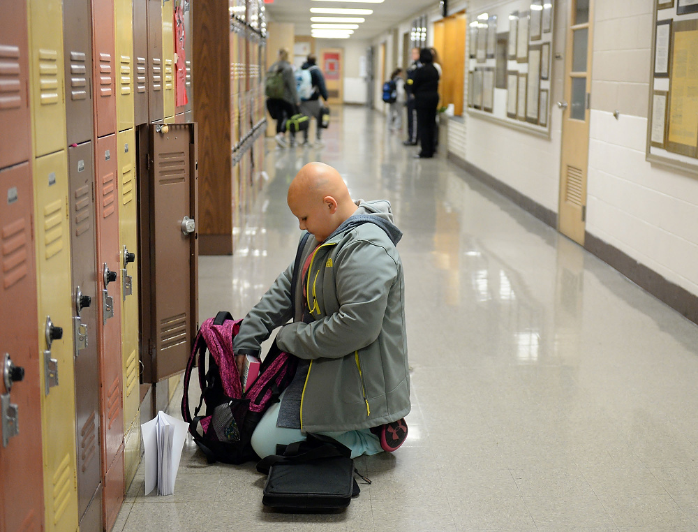 Third Place, George S. Smallsreed Photographer of the Year  - Erin McLaughlin / Sandusky RegisterKarah, a sixth-grader, puts items in her locker before school on Dec. 6, 2017, at Briar Middle School in Perkins Township.