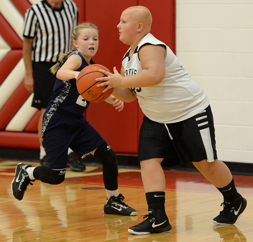 Third Place, George S. Smallsreed Photographer of the Year  - Erin McLaughlin / Sandusky RegisterKarah pivots as she looks for an open teammate during a basketball game against Norwalk on Dec. 10, 2017, at Bellevue Middle School. Karah was dubbed ‘The Intimidator’ because she’s able to intimidate opponents with her bald head.