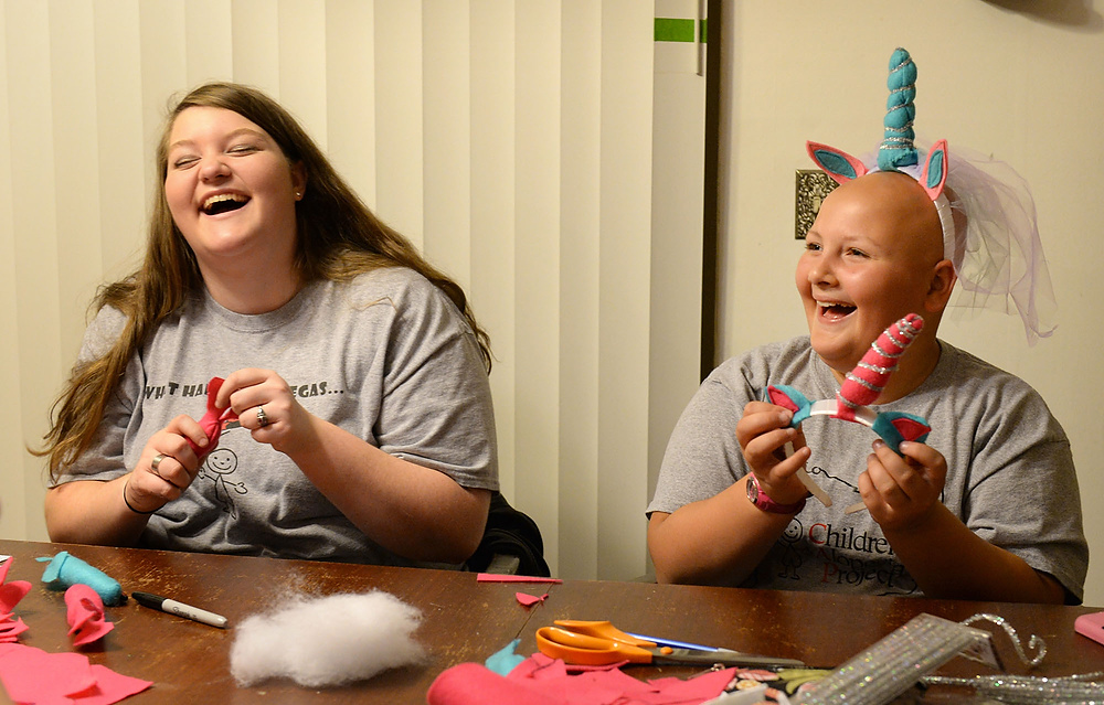 Third Place, George S. Smallsreed Photographer of the Year  - Erin McLaughlin / Sandusky RegisterHaylee Keene and Karah laugh while making unicorn headbands on Nov. 30, 2017. For a class project, Haylee needed to develop a product to give to a charity. Haylee chose to make headbands and visors to promote awareness and self-confidence because the unicorn is a symbol of alopecia. Haylee was inspired by Karah to reveal to her peers that she too has alopecia.