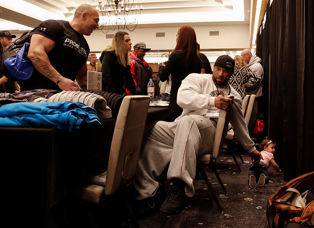 , Ron Kuntz Sports Photographer of the Year - Kyle Robertson / Columbus DispatchArnold Classic competitor Juan Morel stops to get his daughter, Izabella, as she tries to crawl away during a meet and greet with a fan at the Hilton Hotel.  Juan has become fan favorite over the past couple of years. 