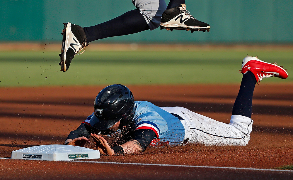 , Ron Kuntz Sports Photographer of the Year - Kyle Robertson / The Columbus DispatchColumbus Clippers center fielder Tyler Naquin (6) steals a base at third base as Gwinnett Braves third baseman Carlos Franco (58) jumps over Naquin during their game at Huntington Park in Columbus on June 16, 2017.  