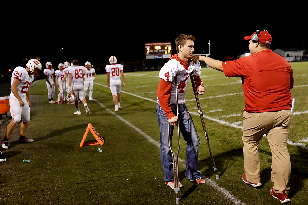 Second Place, Ron Kuntz Sports Photographer of the Year - Katie Rausch / The Blade/Katie RauschEastwood's senior Cade Boos is embraced as his teammates head in at halftime during the Friday, October 6, 2017, at Otsego High School in Tontogany. Boos, three-sport standout, fractured his leg four plays into the team's season-opener. He is supporting his team from the sidelines during a great season. Eastwood beat Otsego, 39-0. 
