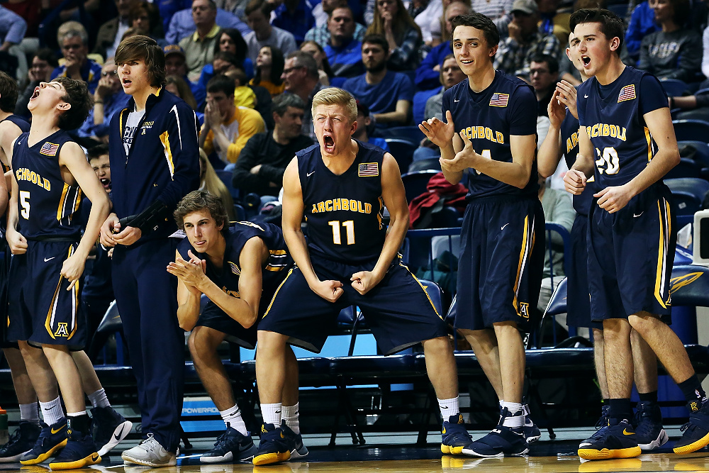 Second Place, Ron Kuntz Sports Photographer of the Year - Katie Rausch / The Blade/Katie RauschArchbold's bench, including Brandon Miller (11), cheers after Archbold's Rigo Ramos (23) scored during the Saturday, March 18, 2017, Division III regional basketball championship match up against Marion at the University of Toledo's Savage Arena. Archbold won, 48-24.