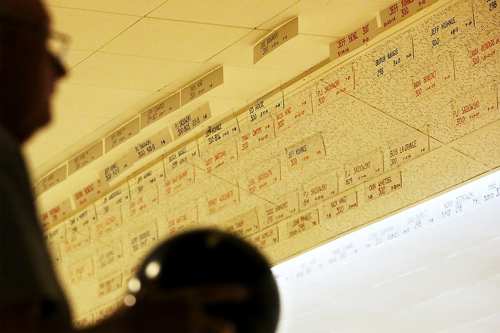 Second Place, Ron Kuntz Sports Photographer of the Year - Katie Rausch / The Blade/Katie RauschA bower lines up his shot under the rows of plaques bearing the handwritten names of alley record holders at Twin Oakes Lanes in North Toledo. Many of the alley's records are kept by hand. 