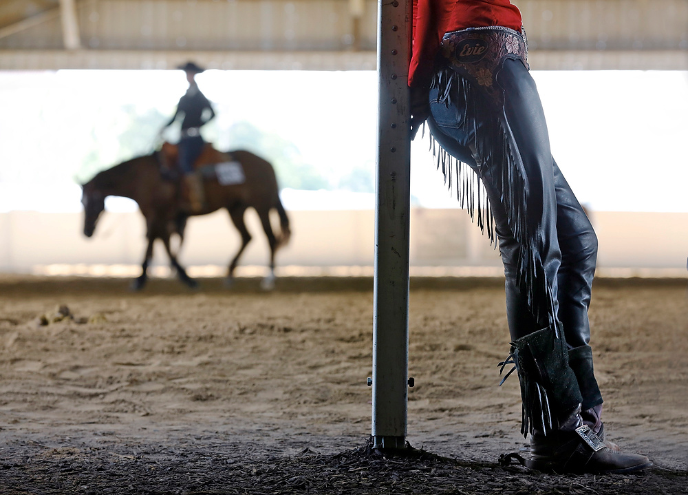 Third Place, Ron Kuntz Sports Photographer of the Year - Barbara J. Perenic / The Columbus DispatchEvie Laney leans on a post in the warm-up arena outide the Celeste Center before competing in NRHA Youth Reining (14-18) during the Quarter Horse Congress at the Ohio Expo Center on Saturday, October 7, 2017. The Congress is the largest single breed-horse show in the world with over 23,500 horse show entries and nearly 6,000 registered American Quarter Horses competing.  