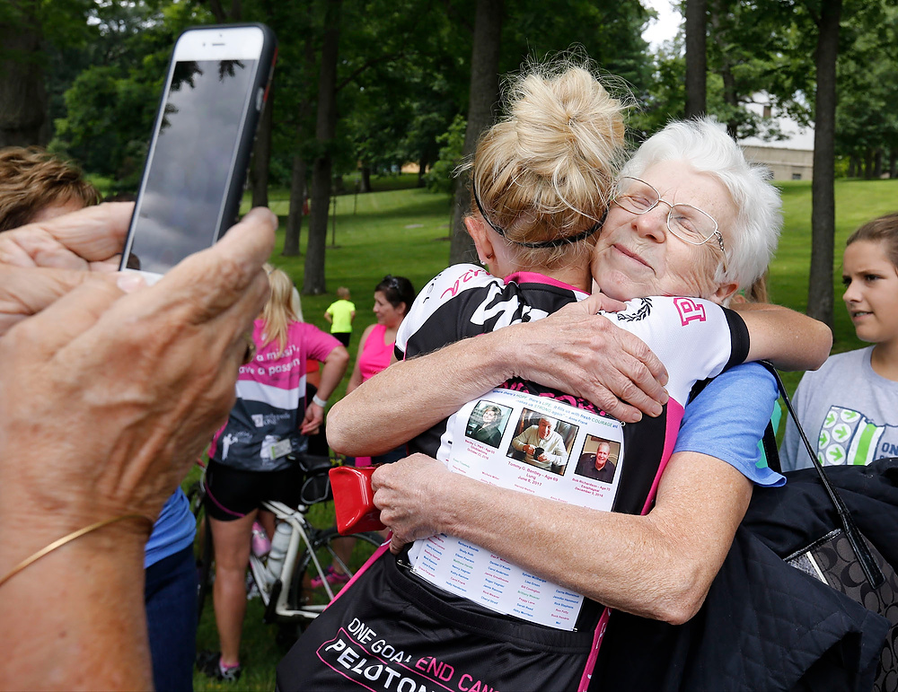 Third Place, Ron Kuntz Sports Photographer of the Year - Barbara J. Perenic / The Columbus DispatchMelonoma and cervical cancer survivor Shannon Rece of Hilliard, who rode 55 miles, gets a hug from her mother Anita Fitzpatrick, also of Hilliard, at the Pelotonia finish line at Kenyon College in Gambier.