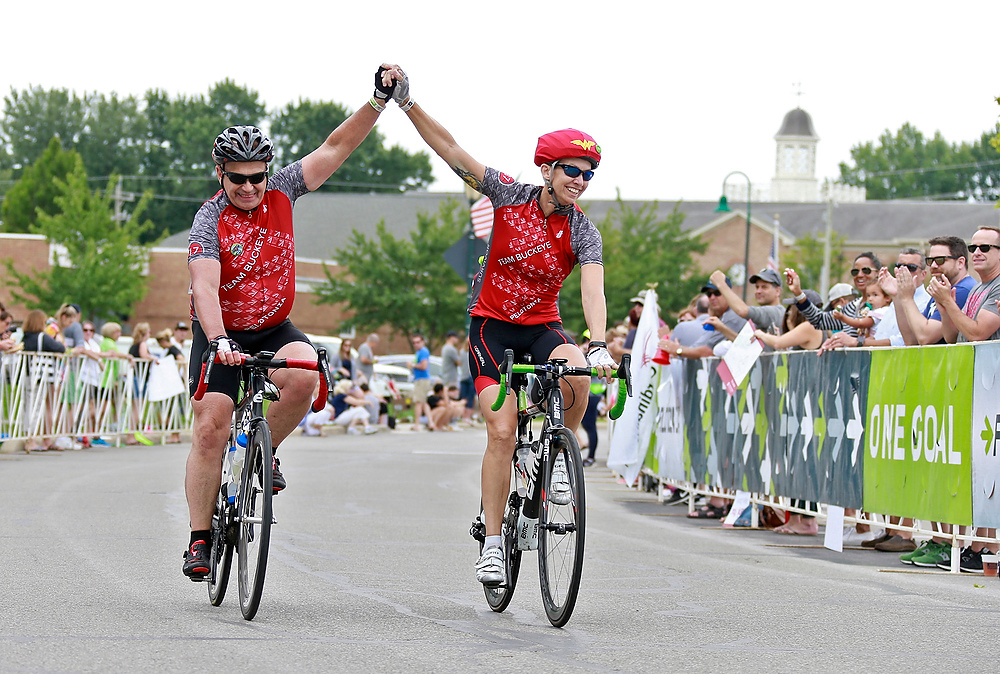 Third Place, Ron Kuntz Sports Photographer of the Year - Barbara J. Perenic / The Columbus DispatchAlan and Kathy Koontz of Team Buckeye CTCL ride hand-in-hand across the Pelotonia finish line in New Albany. Kathy is a high roller fundraiser and a cancer survivor who was treated at the OSU James Cancer Hospital, which benefits financially from Pelotonia. 