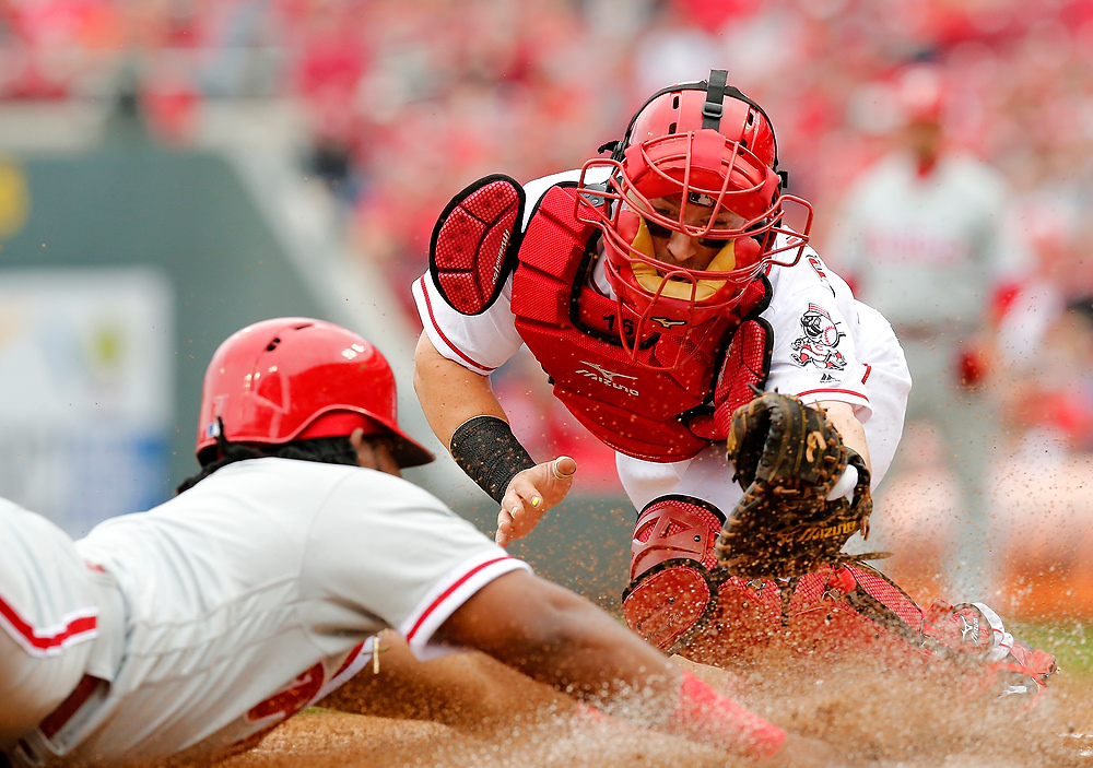 Award of Excellence, Ron Kuntz Sports Photographer of the Year - Sam Greene / The Cincinnati EnquirerPhiladelphia Phillies third baseman Maikel Franco (7) slides in safe at home ahead of a tag from Cincinnati Reds catcher Tucker Barnhart (16) on a Michael Saunders double to center field in the top of the first inning of the MLB Opening Day game between the Cincinnati Reds and the Philadelphia Phillies at Great American Ball Park in downtown Cincinnati on Monday, April 3, 2017. 